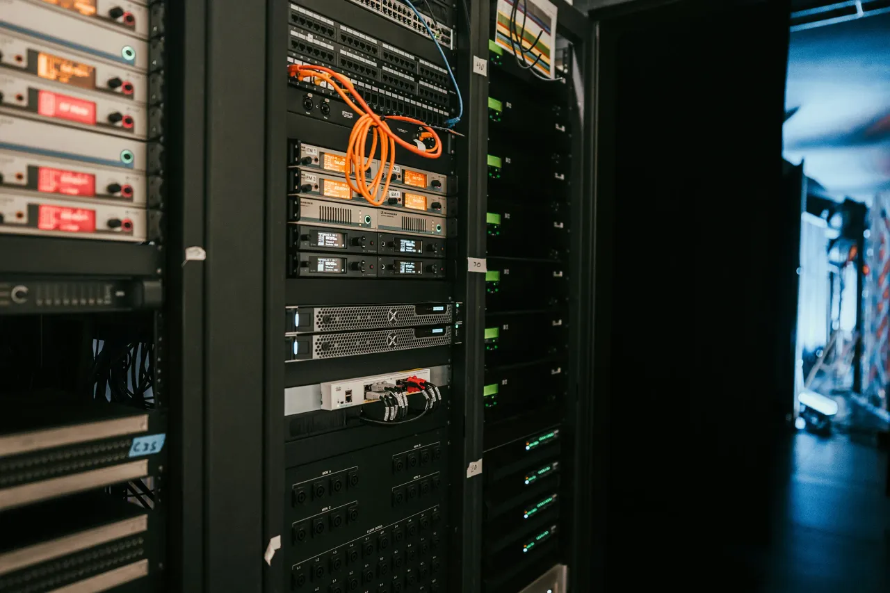 IKBSystems technician performing AV system maintenance.