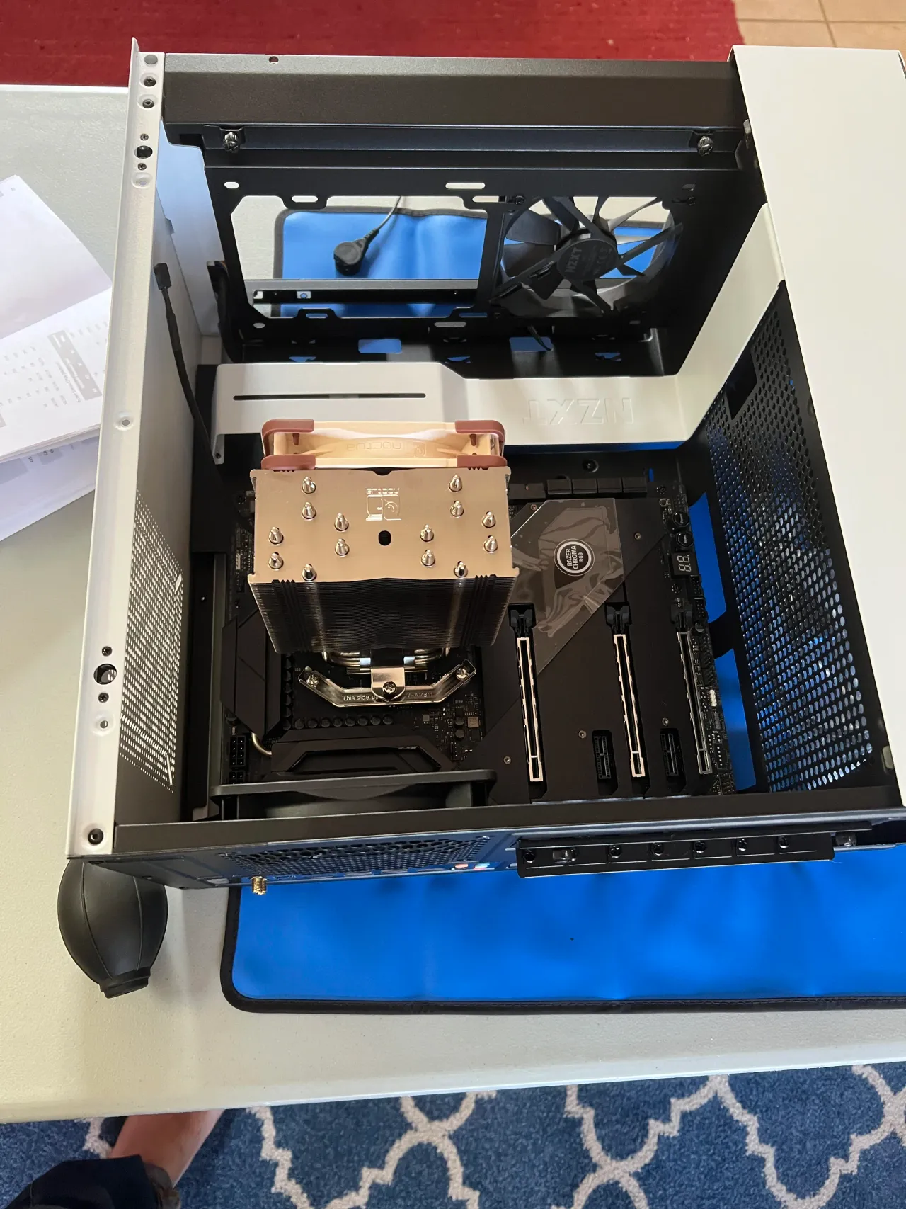 The custom workstation PC during assembly, with the CPU cooler and motherboard exposed.