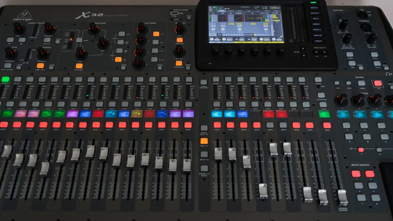 Close-up of the digital mixing console in the sound booth.