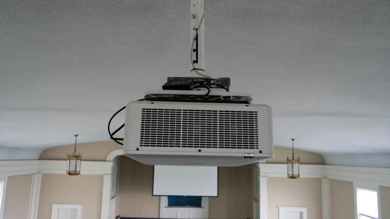 A large-venue projector mounted to the sanctuary ceiling.