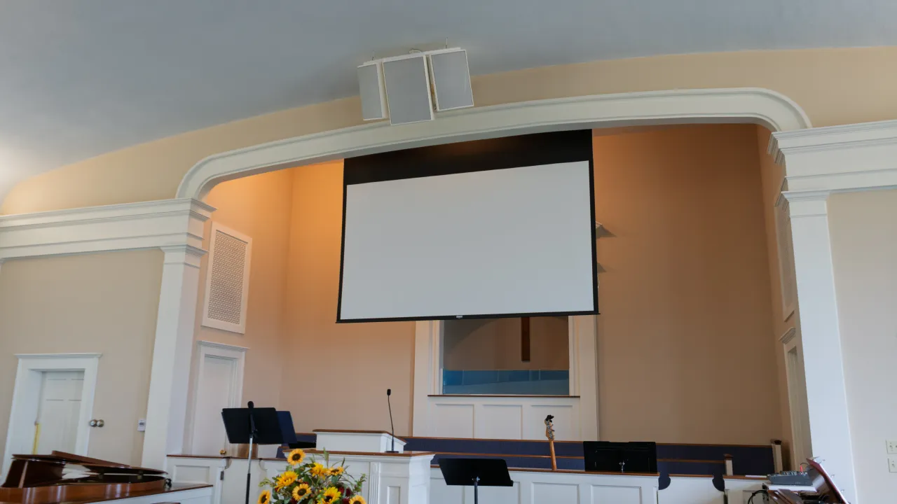 A retractable projection screen above the pulpit at the front of the Sulphur Spring Baptist Church sanctuary.
